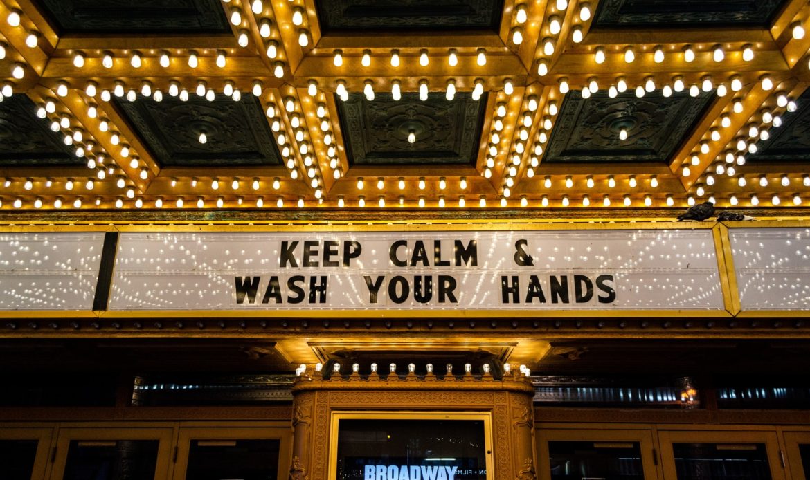 a broadway sign saying: "Keep calm and wash your hands" 
all in caps
