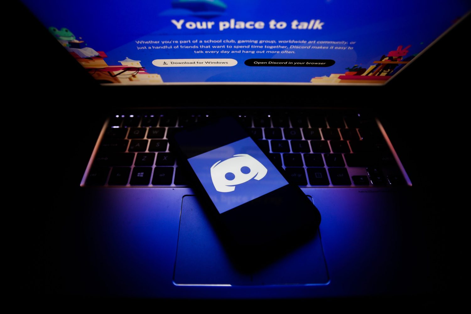 Discord app opened on smartphone and laptop